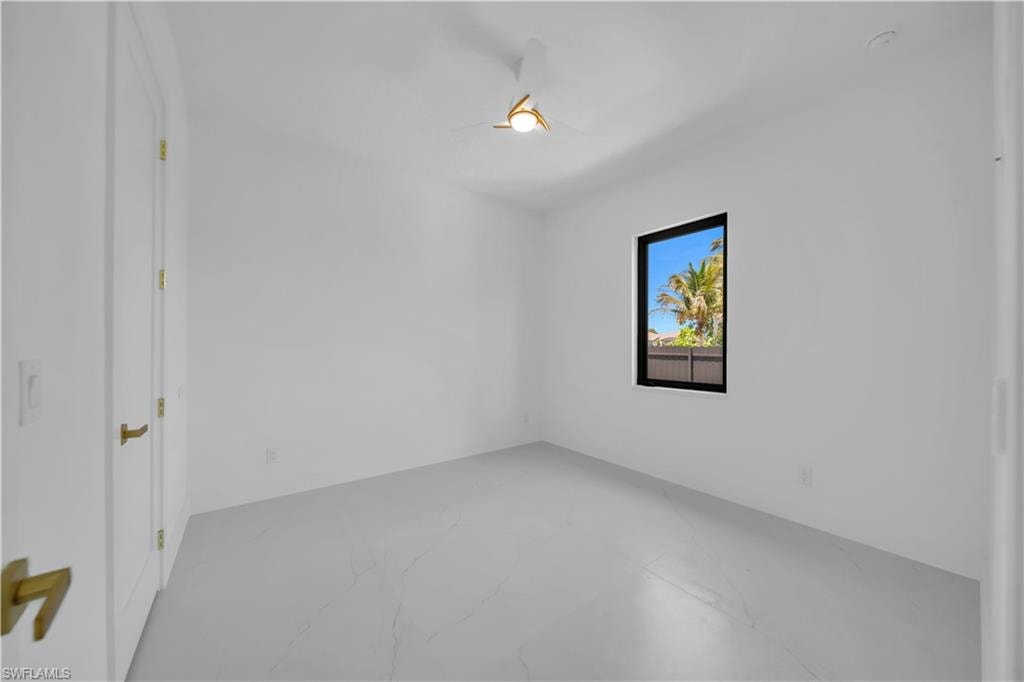 Bright interior space featuring white walls and light-toned tile flooring