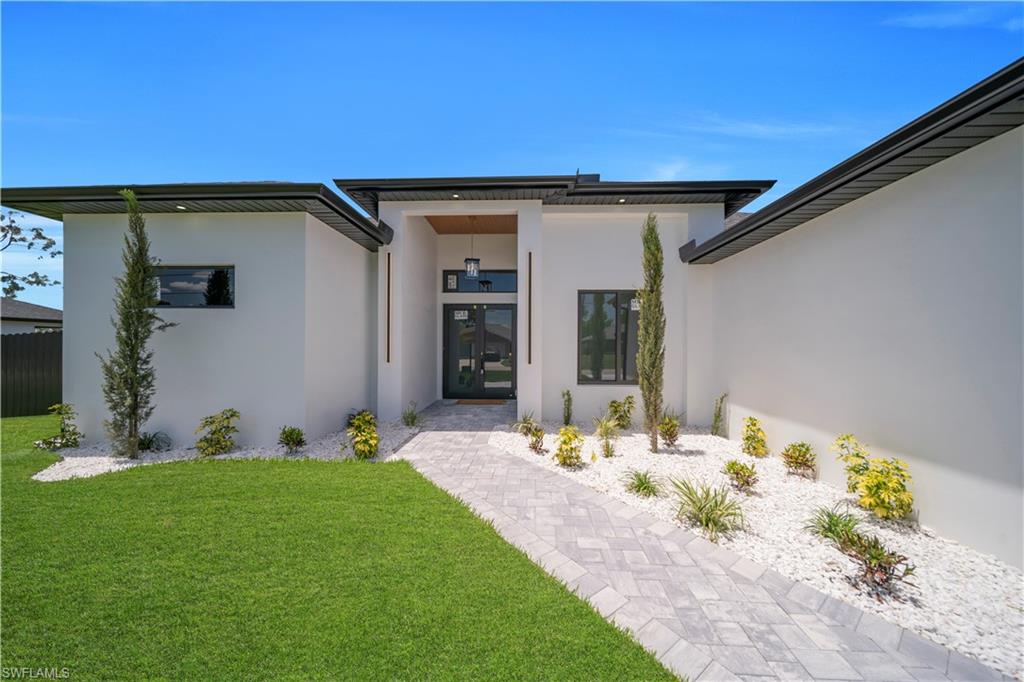 Contemporary exterior design with white stucco finish and dark soffits