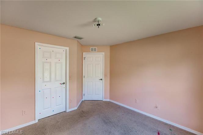 Unfurnished bedroom with carpet floors and baseboards