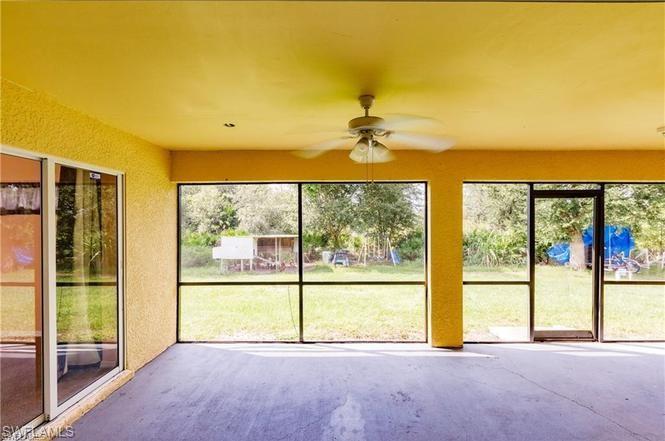 Unfurnished sunroom featuring ceiling fan