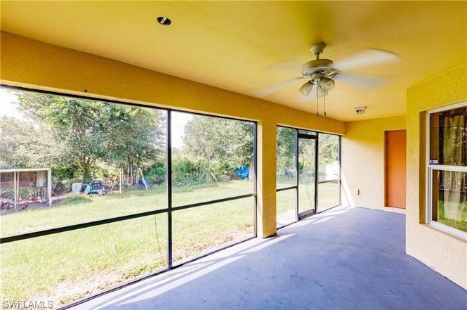 Unfurnished sunroom featuring ceiling fan