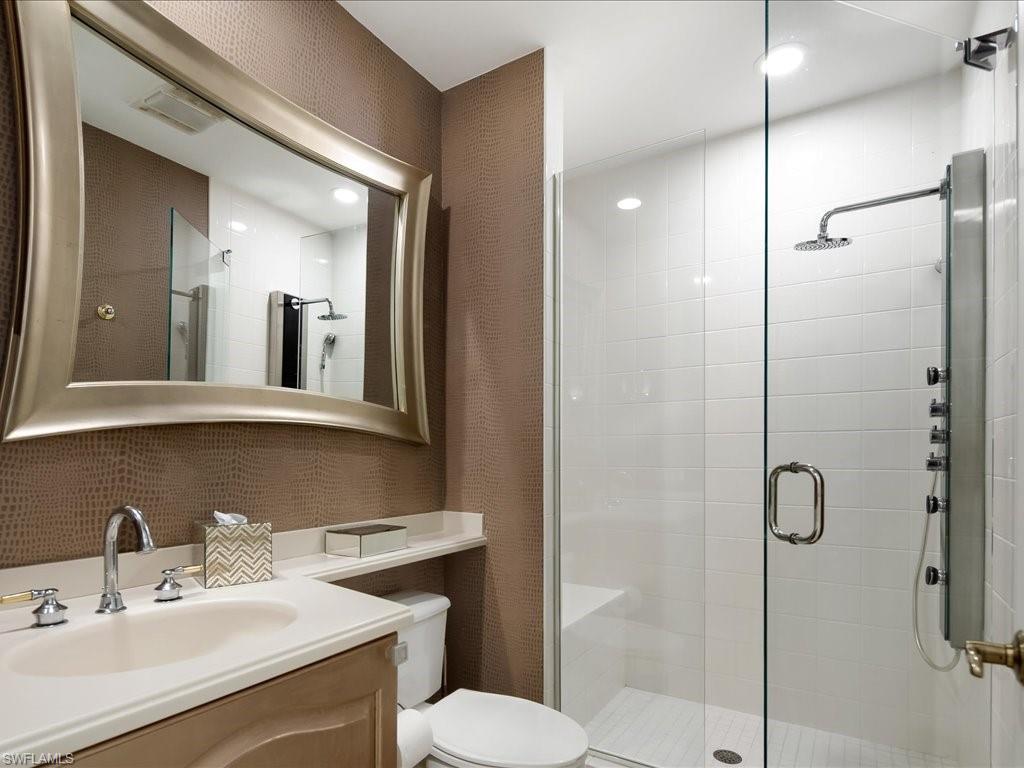 Full bath featuring a shower stall, vanity, and recessed lighting
