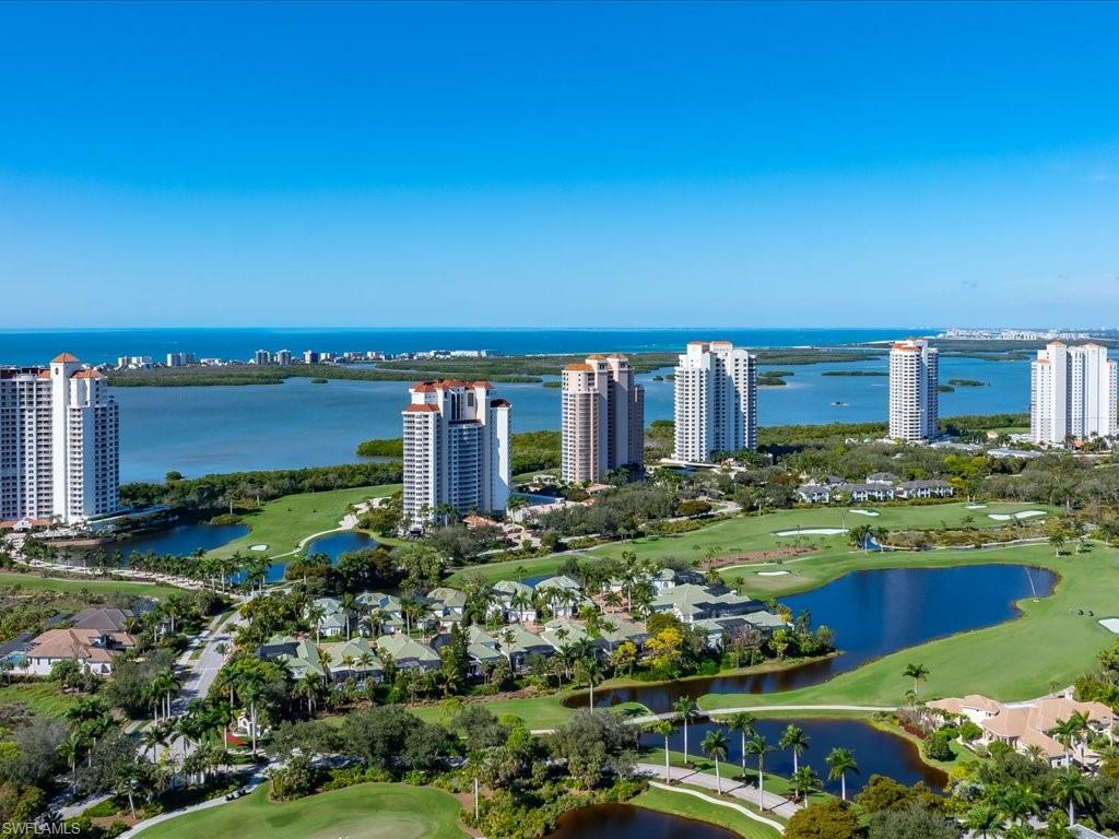 View of urban area featuring a nearby body of water and a golf course