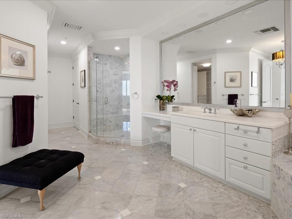 Bathroom with vanity, a marble finish shower, ornamental molding, and recessed lighting