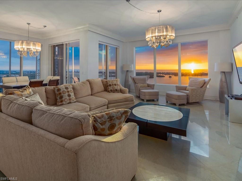 Living area featuring a chandelier, crown molding, and tile patterned floors