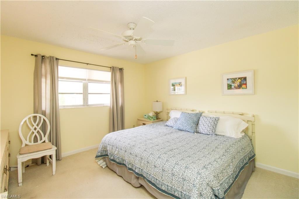 Bedroom featuring light carpet and ceiling fan