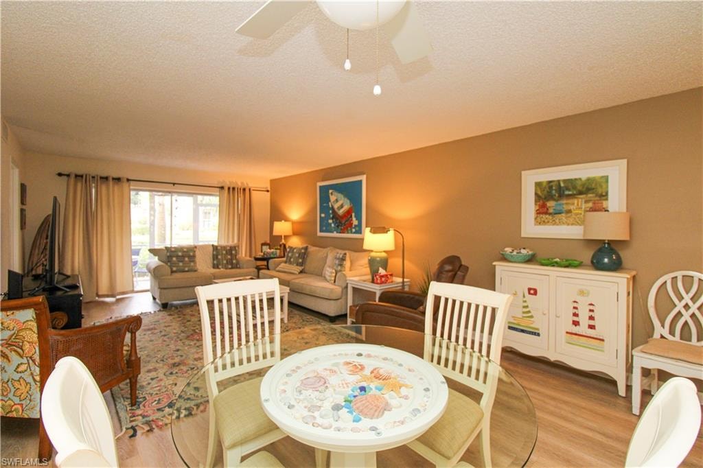Dining room featuring ceiling fan, a textured ceiling, and light hardwood / wood-style floors