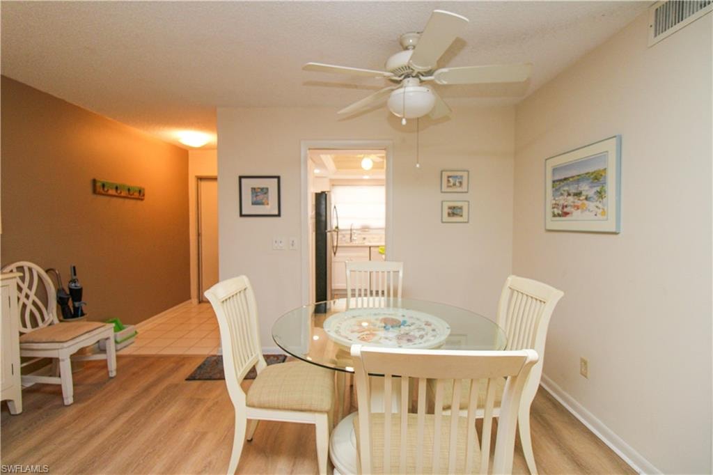 Dining space featuring ceiling fan and light hardwood / wood-style floors