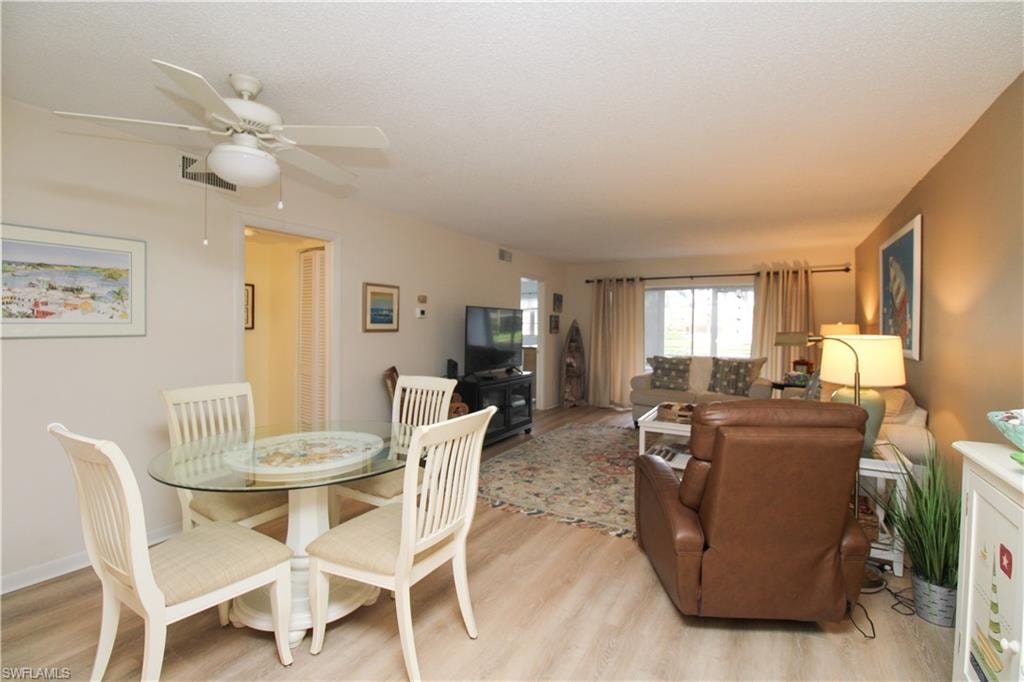 Dining room featuring ceiling fan and light hardwood / wood-style flooring