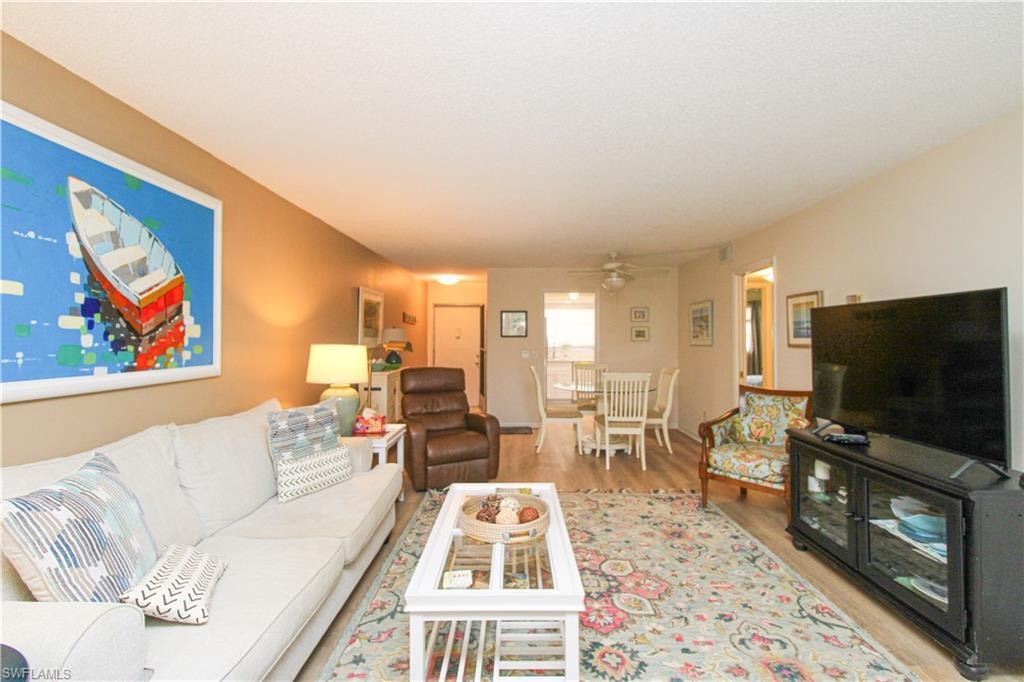 Living room featuring ceiling fan and light hardwood / wood-style flooring