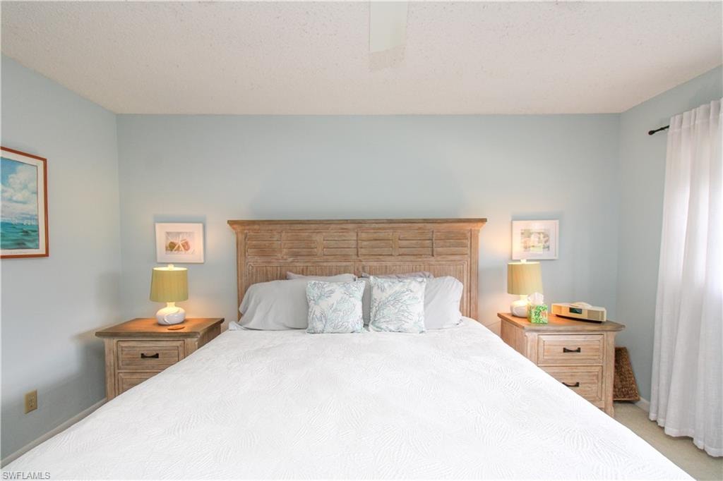 Bedroom featuring light carpet and ceiling fan