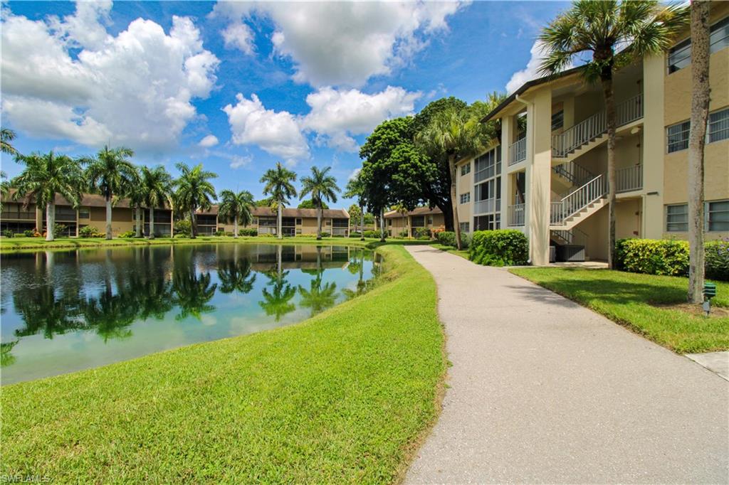View of property's community featuring a yard and a water view