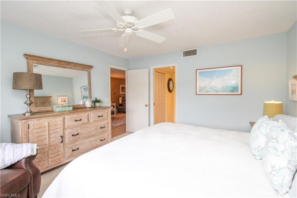 Carpeted bedroom featuring ceiling fan