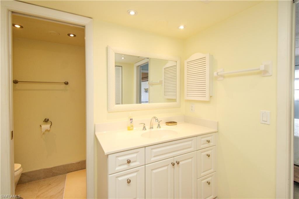 Bathroom with vanity, toilet, and tile patterned flooring