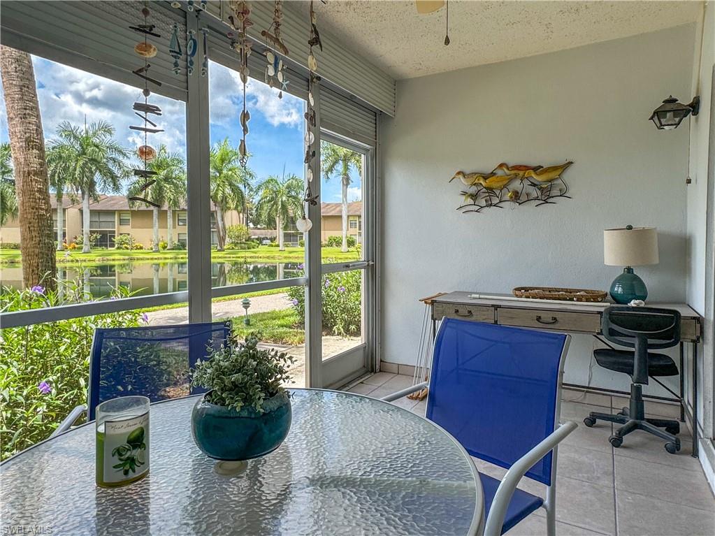 Sunroom / solarium with a water view