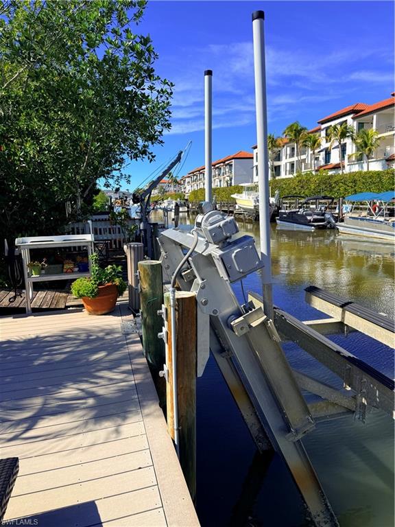 Dock area with a water view and boat lift