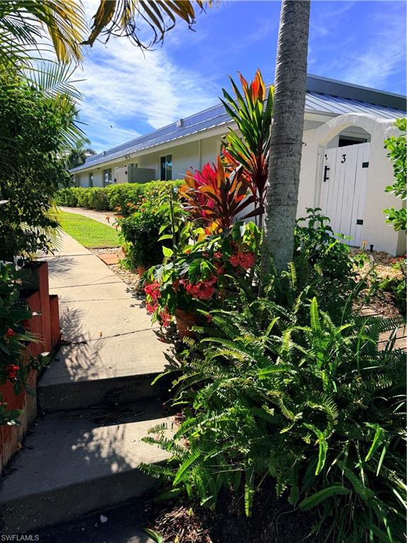 Entry filled with flowers and fauna leading to the dock