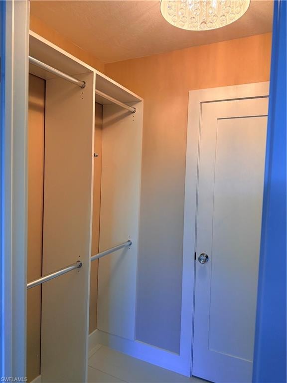 Primary Walk in closet featuring custom closets