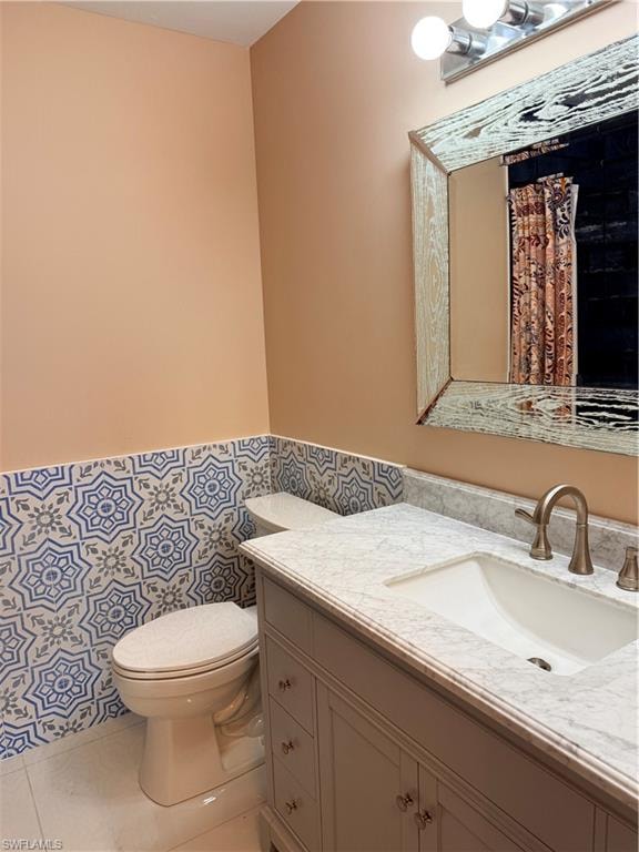 Primary bathroom featuring light tile patterned flooring, vanity, with Italian tile walls