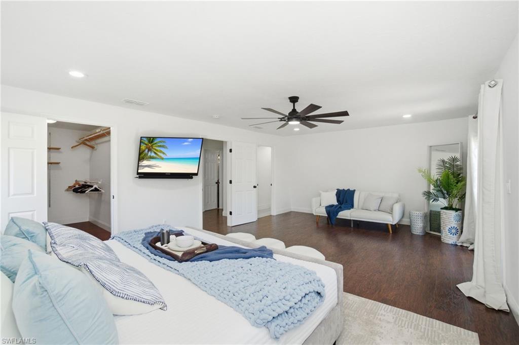 Spacious primary en-suite has an abundance of natural light and room for a separate seating area near the entry and balcony French doors.