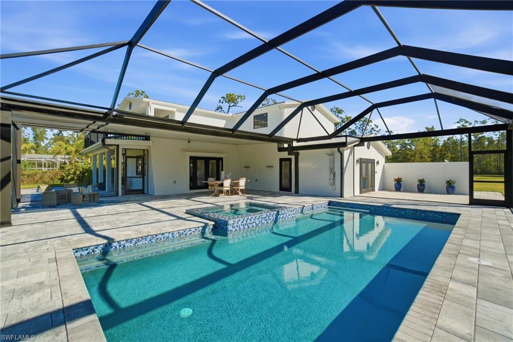 Enjoy dining poolside 365 or plan that family reunion you have always wanted with an abundance of paved custom pool hard scape. Perfect for high table gatherings and set over stunning, acreage, green, tropical views.
