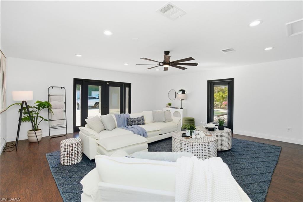 The main living area leads out to the covered pool area, as well as the driveway and garage