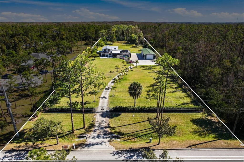Protected by a private, electric gate, Foxtail Palms welcome you home, while the entire 2.39 acres are fenced in