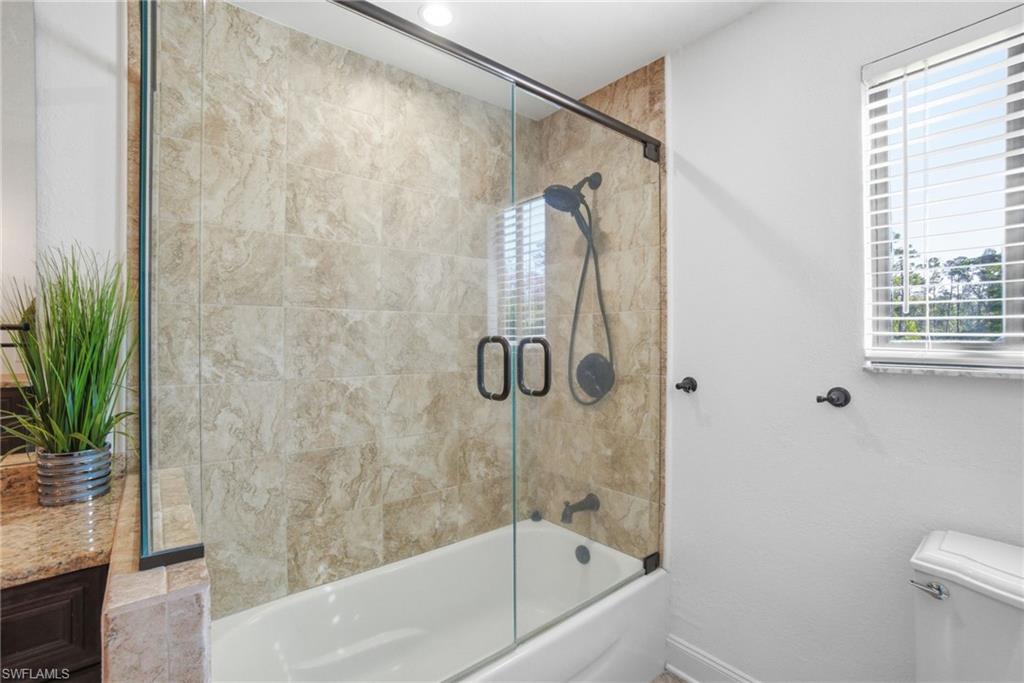 Upstairs full bathroom features a separate tub and bright open feel.