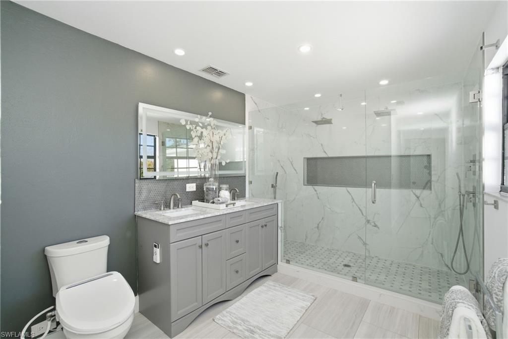 3rd primary modern en-suite bath was recently  added boasting frameless glass doors, stone like tile finishes and a open, bright airy feel with an abundance of light.