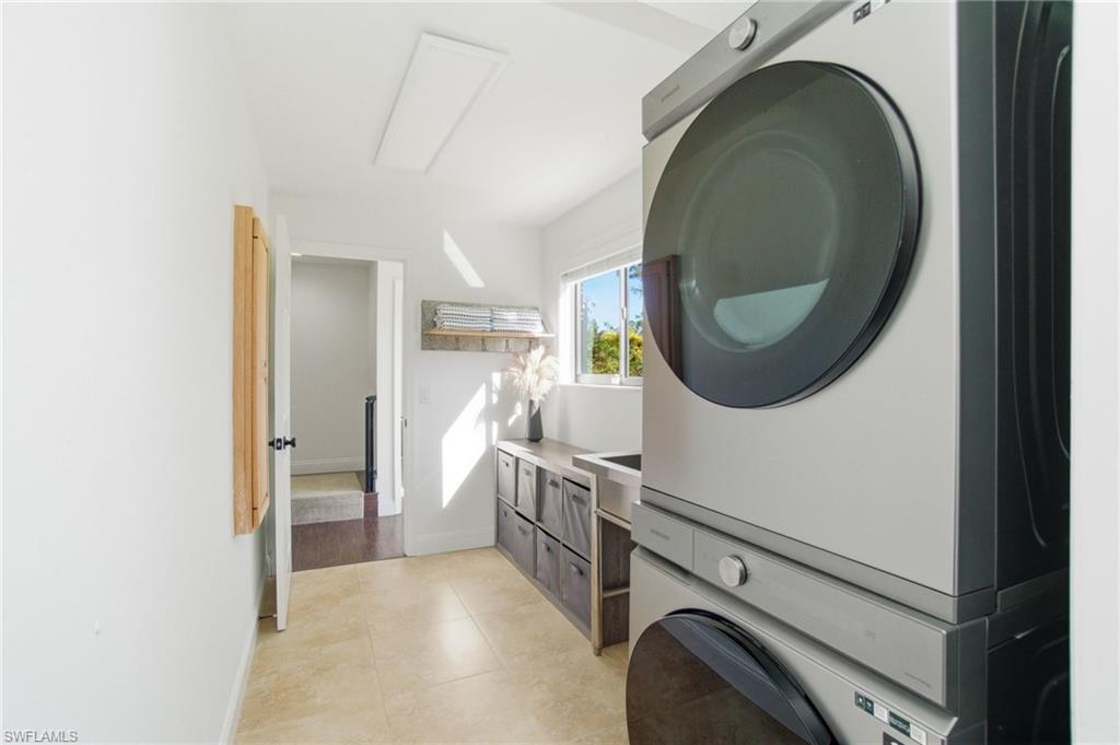Super-sized washer and dryer, and farmhouse sink.  The laundry area has two entry accesses. Doubling as a mudroom from the acreage exterior door by the den..