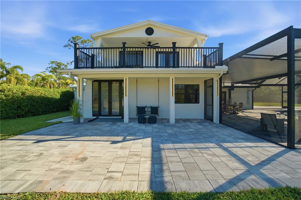 Front porch swing and plenty of additional paved space for outdoor entertainment, while the second floor offers a private Primary Suite balcony