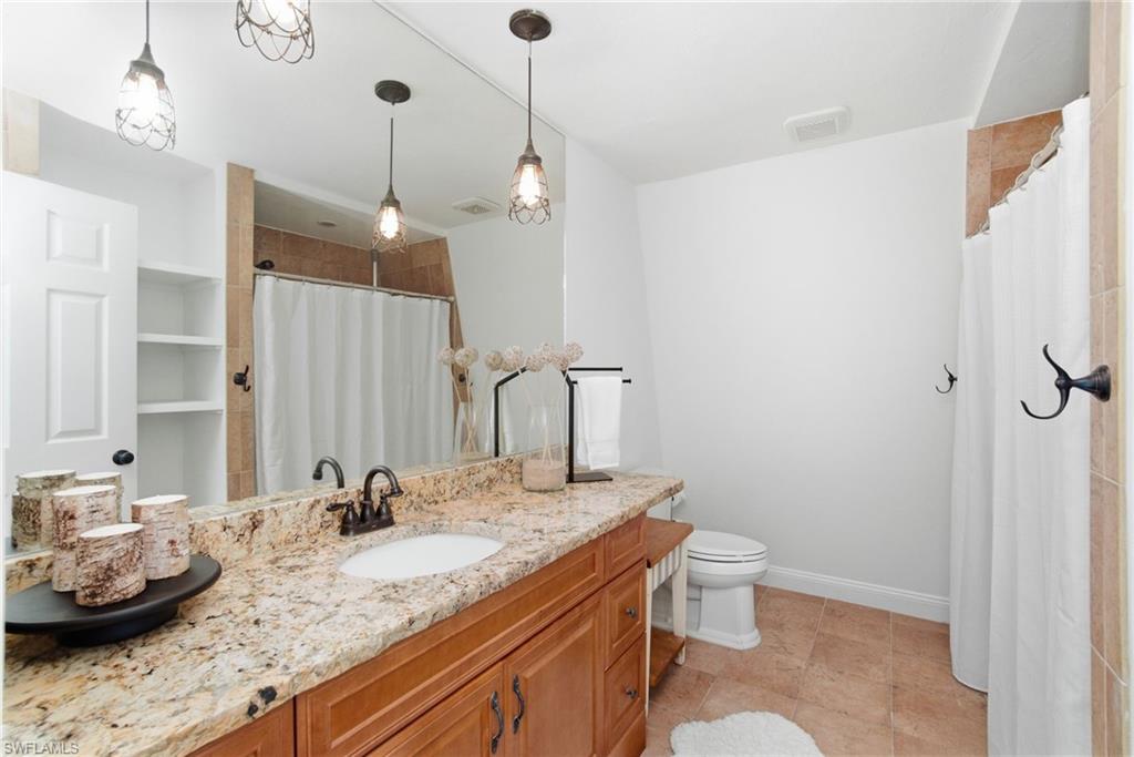 Guest 1st floor full bath services the den and all main, communal areas. Perfect for entertaining with proximity close to the pool.