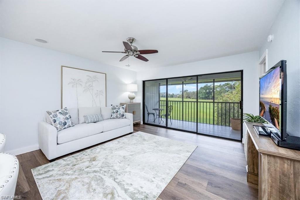Living area with wood finished floors and a ceiling fan