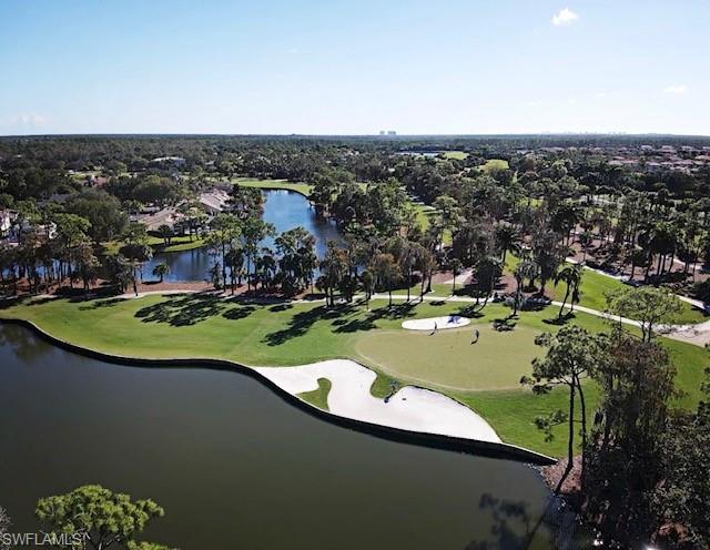 View of property location with a golf club, a nearby body of water, and nearby suburban area
