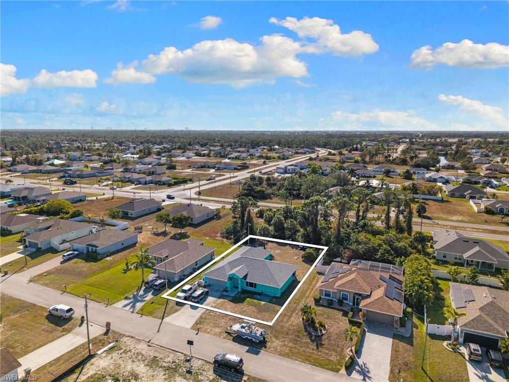 Aerial perspective of suburban area featuring property boundaries highlighted