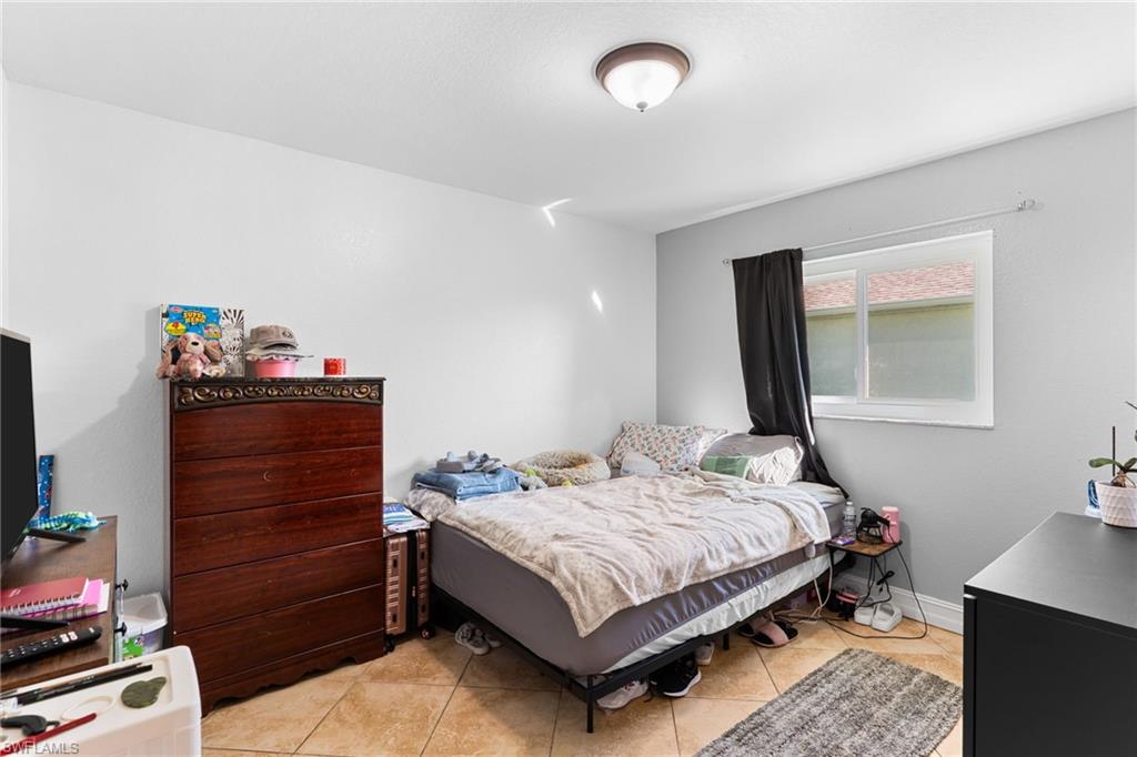Bedroom with light tile patterned floors