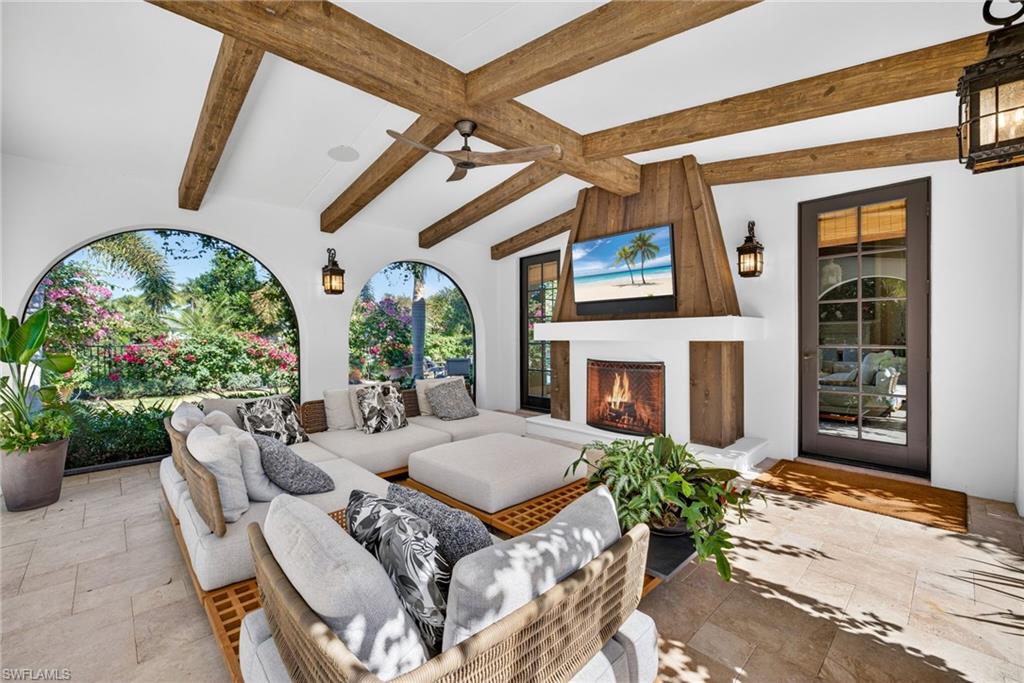 View of patio featuring an outdoor living space with a fireplace and ceiling fan