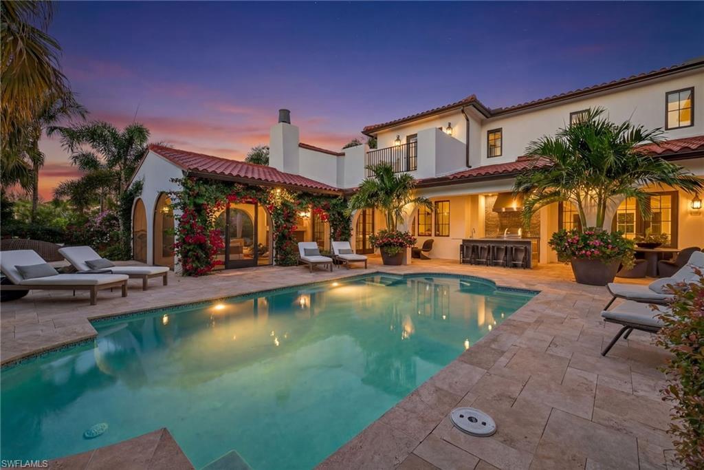 Pool at dusk featuring an outdoor pool and a patio