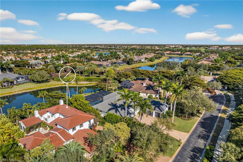 Aerial view of residential area featuring a nearby body of water