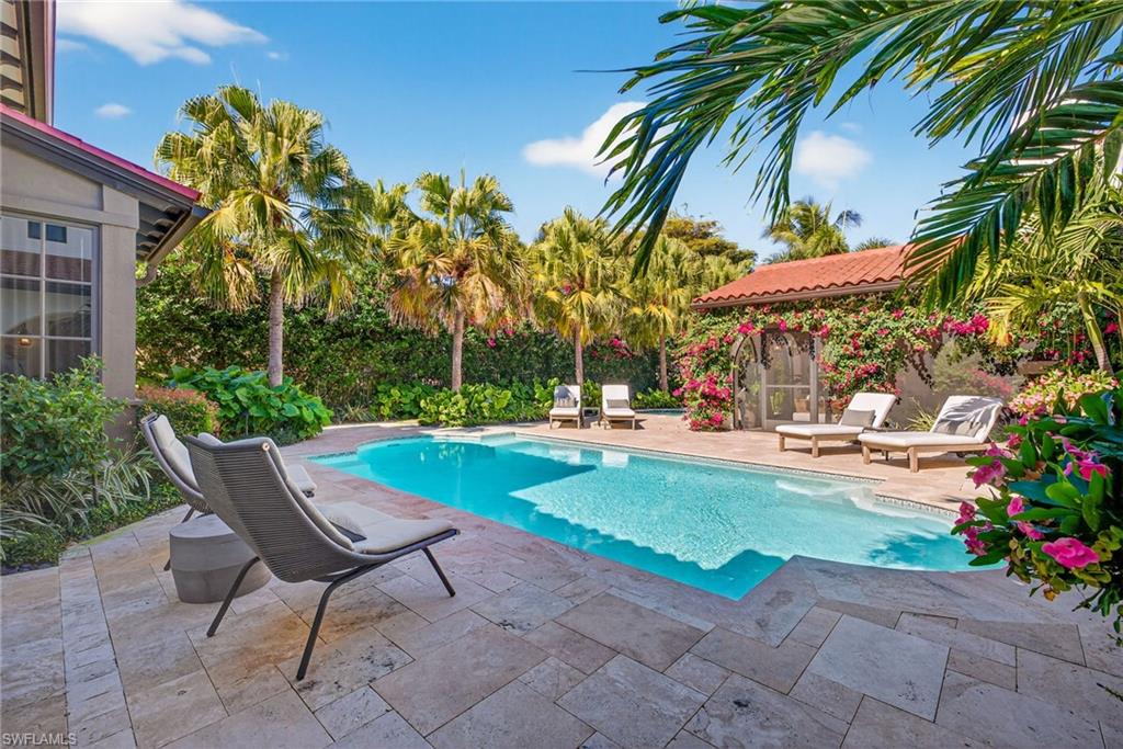 Outdoor pool with a patio and an outbuilding