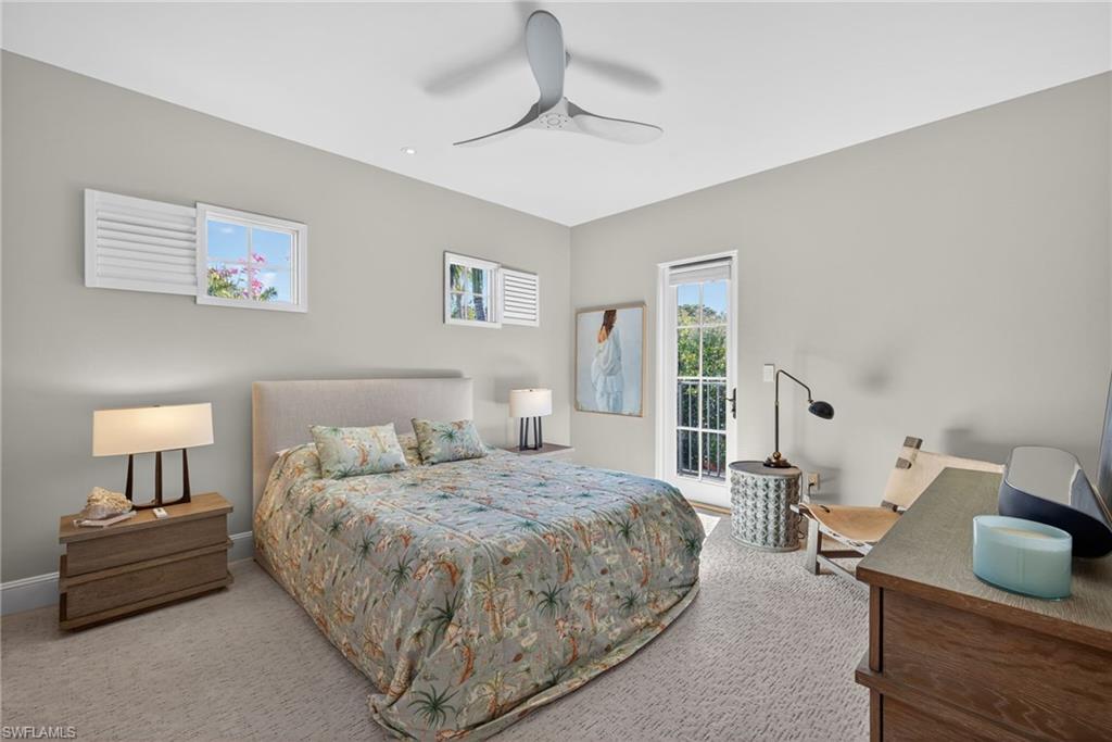 Carpeted bedroom with ceiling fan and baseboards