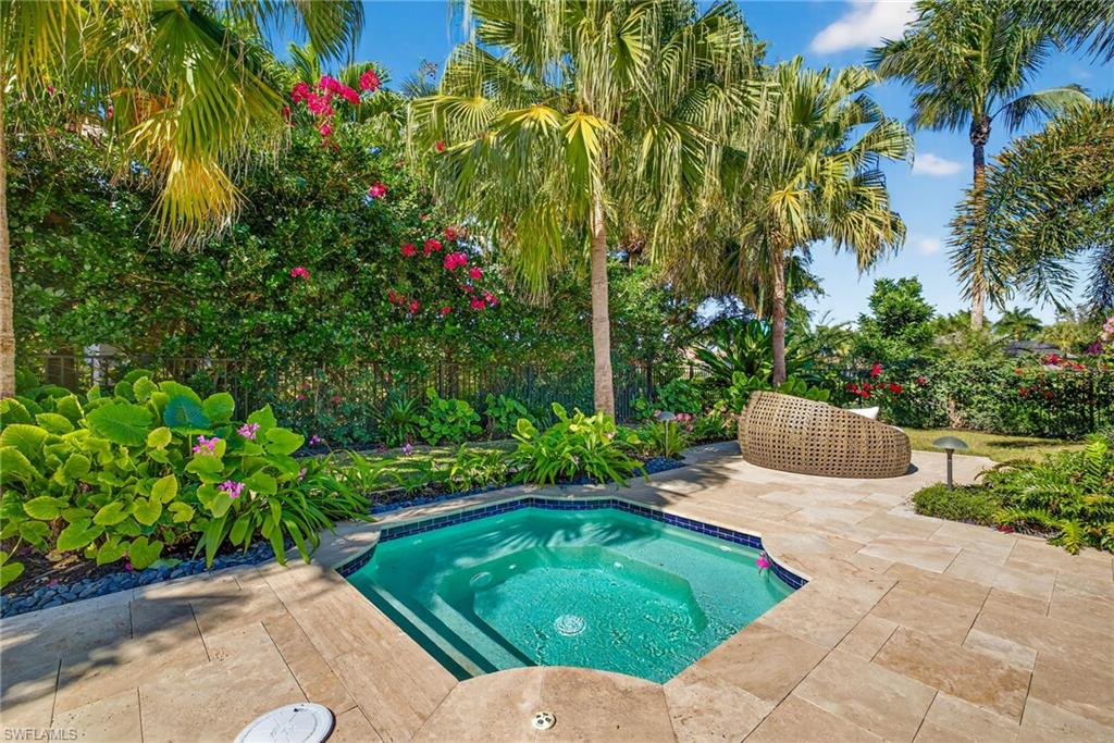 View of swimming pool with a fenced backyard, a patio area, and an in-ground hot tub