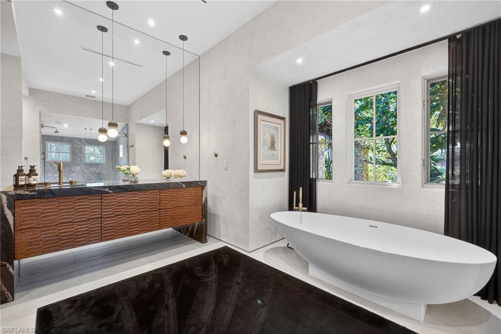 Bathroom with a soaking tub, vanity, recessed lighting, and walk in shower