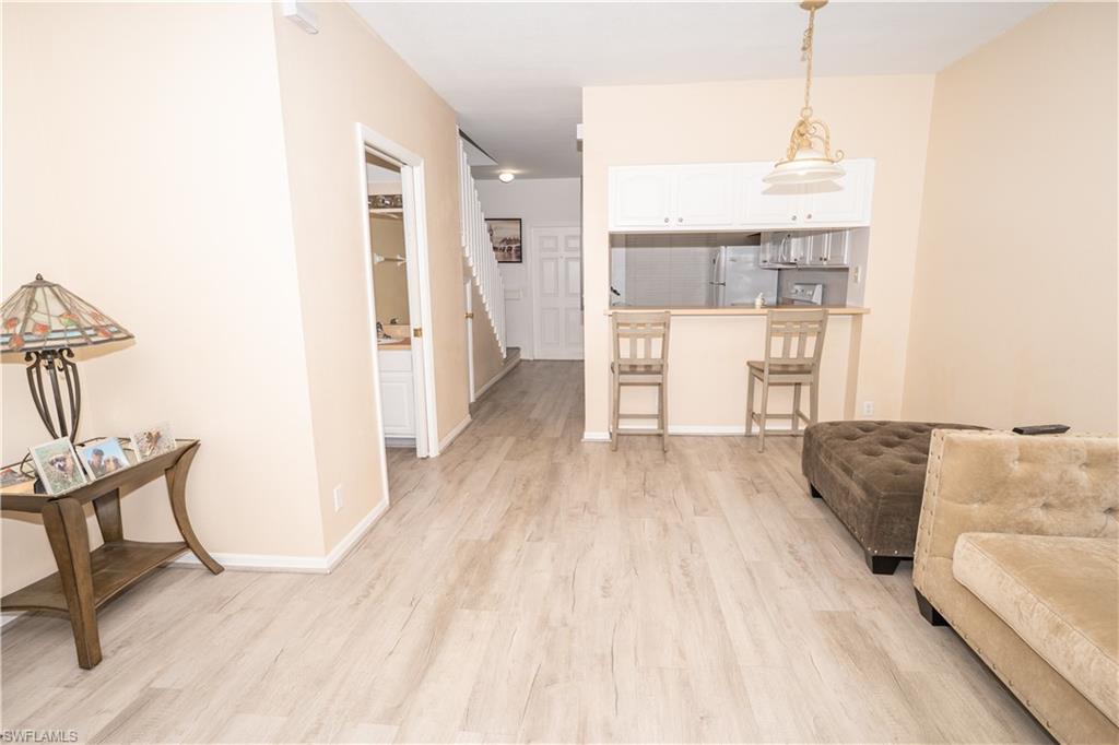 Living area featuring light wood-style flooring and baseboards