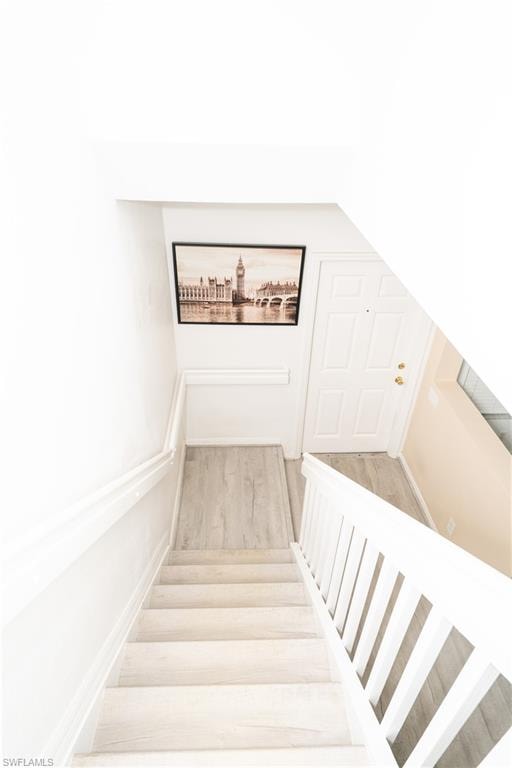 Stairs featuring wood finished floors