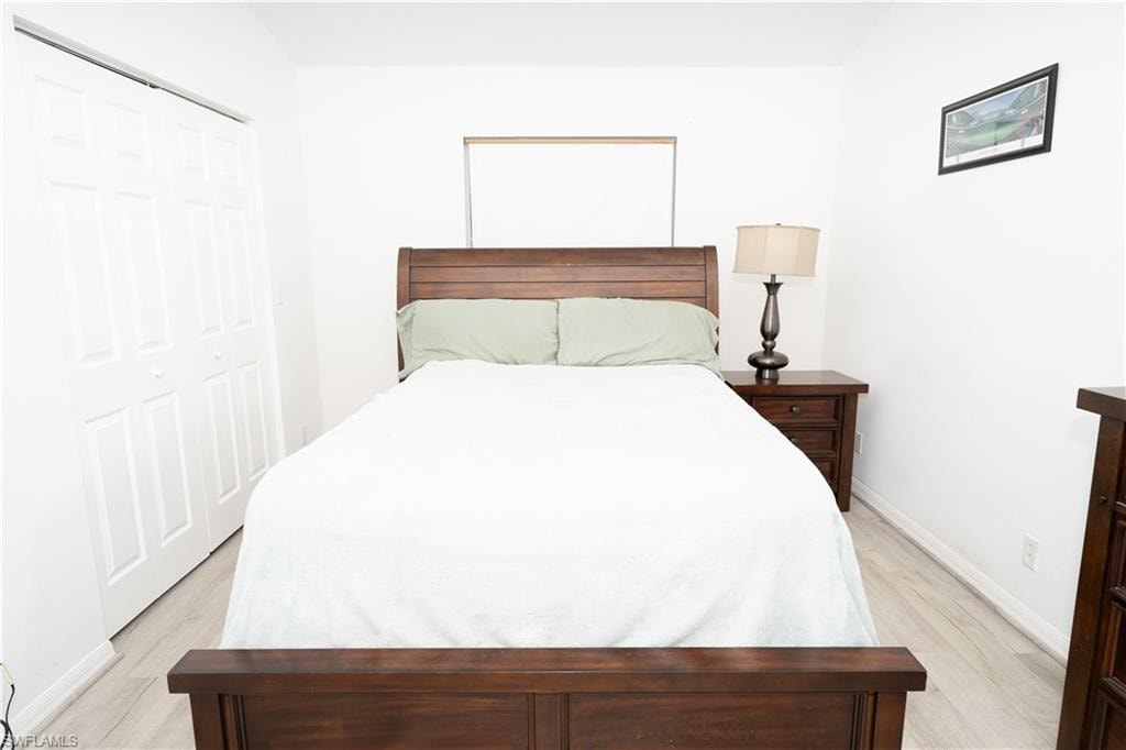Bedroom featuring light wood-style flooring and a closet