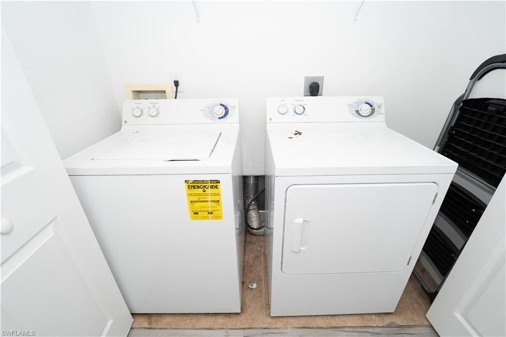 Washroom featuring washing machine and dryer