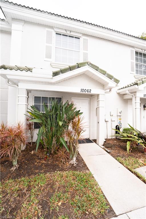 View of exterior entry with stucco siding