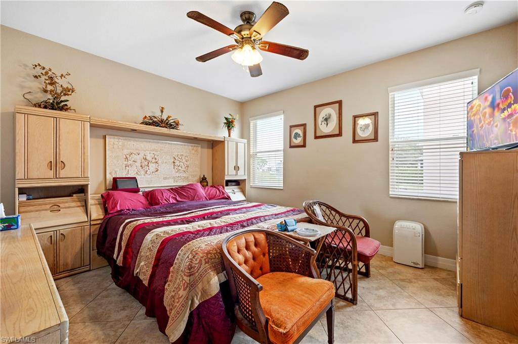 Bedroom featuring light tile patterned floors and a ceiling fan