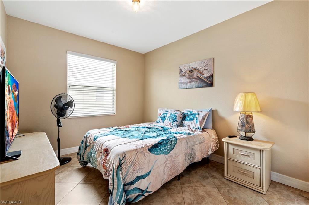 Bedroom with baseboards and light tile patterned floors